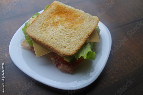 Sandwich with bacon, cheese and fresh vegetables