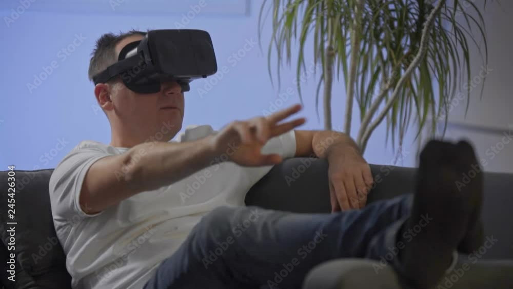 man in white shirt enjoying vr on sofa virtual reality googles
man in white shirt enjoying vr on sofa virtual reality googles