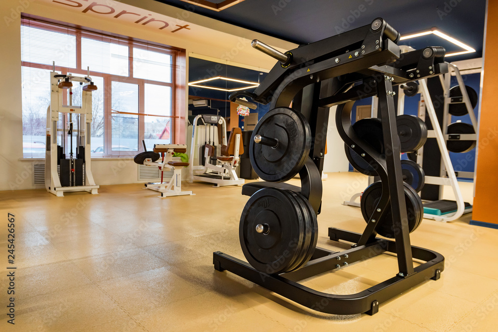 New fitness machines in modern gym interior New fitness machines in modern gym interior