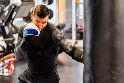 Male boxer does uppercut in modern gym © Yakov