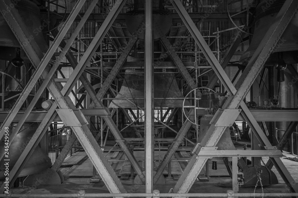 Black and white photo of beams and bell in the cathedral