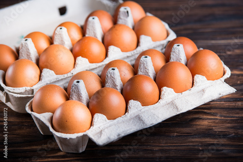Fresh brown eggs on rustic table.