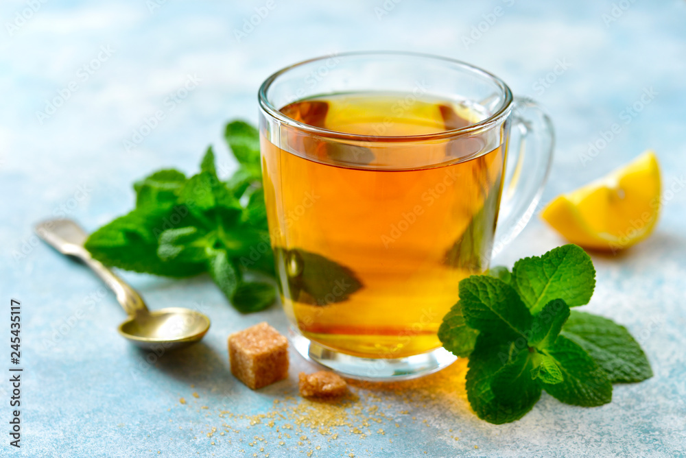 Mint tea with lemon in a glass cup.