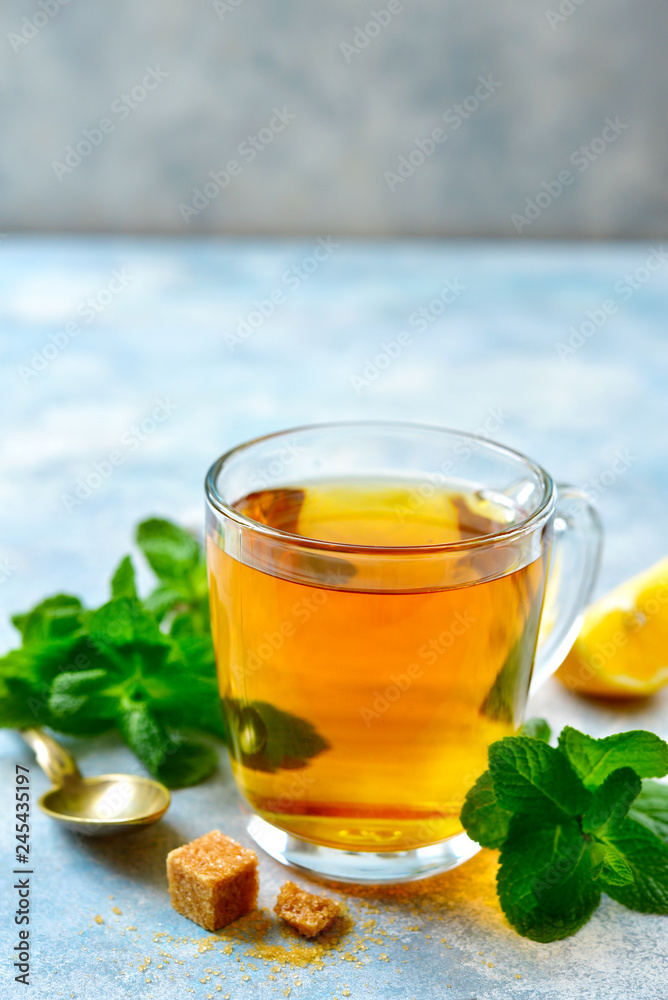 Mint tea with lemon in a glass cup.