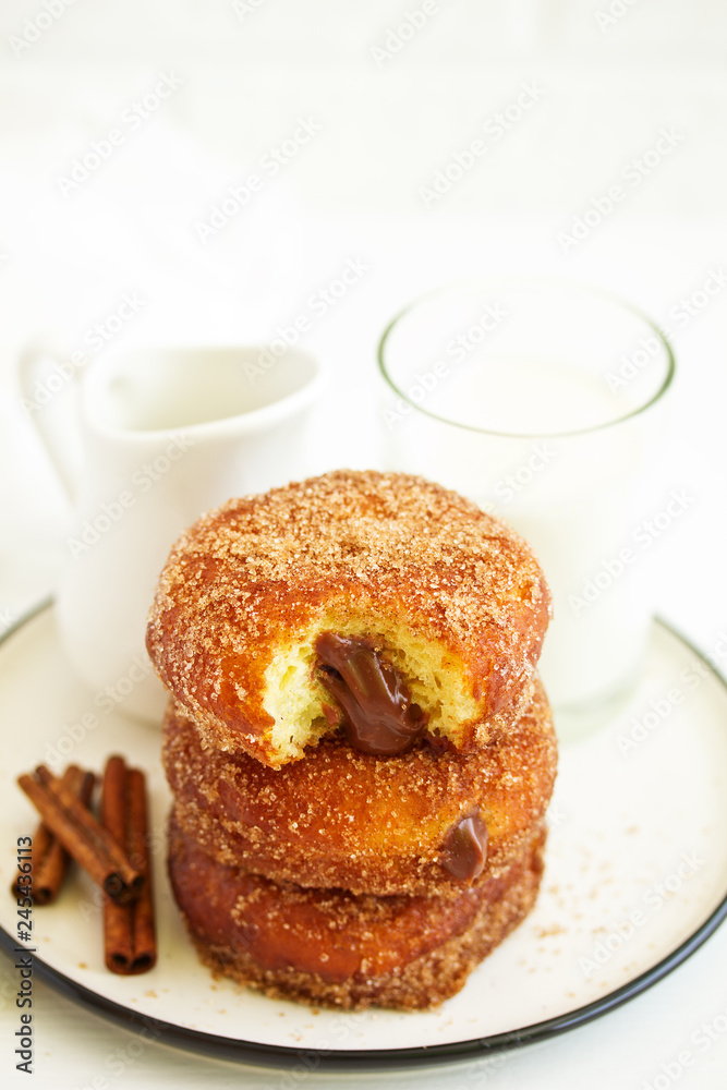 Donuts with cinnamon and chocolate cream. Homemade baking. Selective focus. Donuts with cinnamon and chocolate cream. Homemade baking. Selective focus.