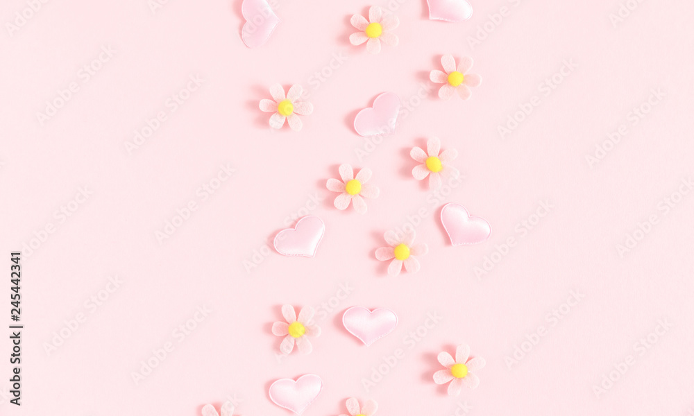 Fototapeta premium Valentine's Day background. Floral decor and pink hearts on light pink pastel background. Valentines day concept, design. Flat lay, top view, copy space 