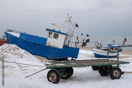 Fishing boats stretched out to the sea. Fishing port in Central Europe.