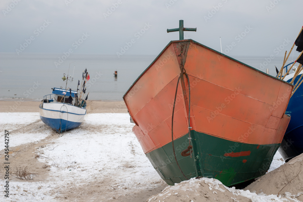 Fishing boats stretched out to the sea. Fishing port in Central Europe.