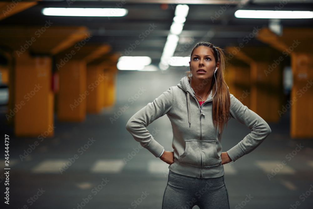 Fototapeta premium Young athlete woman is training in garage