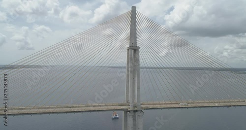 Low aerial beside cars crossing the cable-stayed Rio Negro Bridge that links the cities of Manaus and Iranduba in the Brazilian Amazon photo