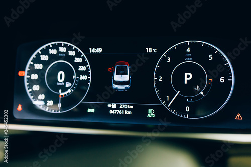 Modern car or automobile dashboard panel. Car HUD Speedometer instrument panel. Illuminated panel speed display car interior.