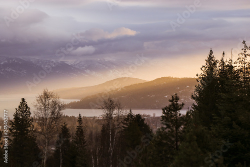 Sun Rays Over Mountain Valley at Sunset in Winter