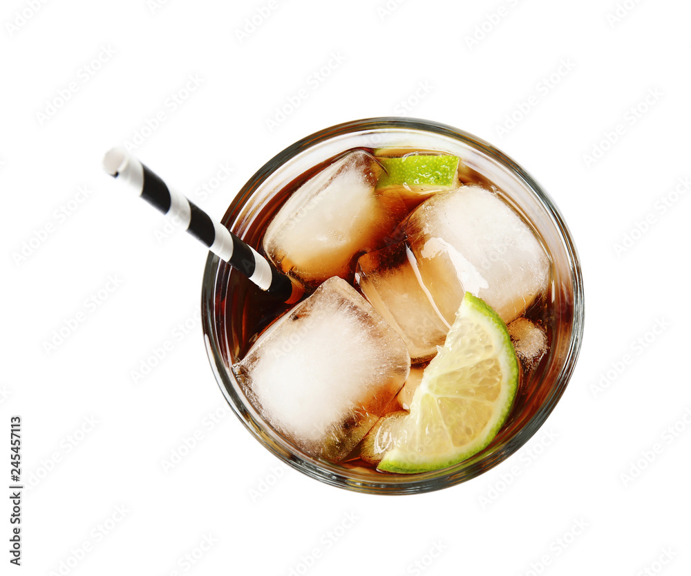 Glass of cocktail with cola, ice and cut lime on white background, top view - obrazy, fototapety, plakaty 