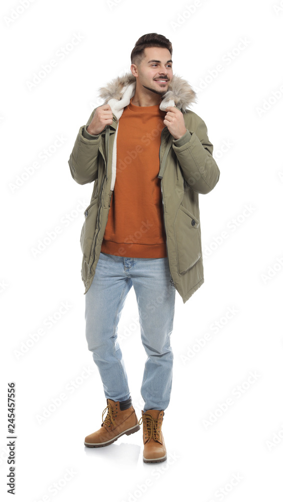 Young man wearing warm clothes on white background. Ready for winter vacation Young man wearing warm clothes on white background. Ready for winter vacation