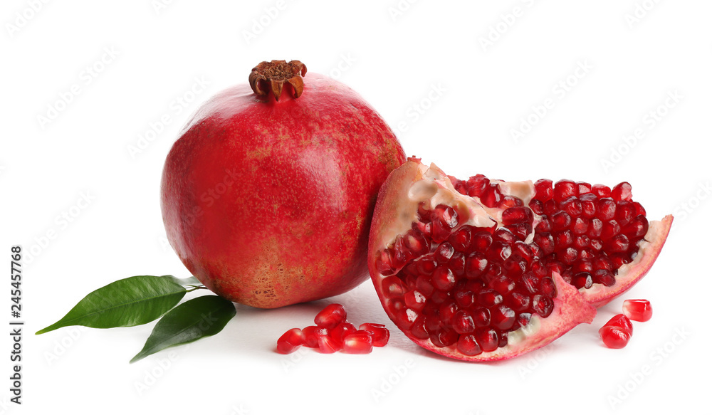 Ripe pomegranates with leaves on white background Ripe pomegranates with leaves on white background