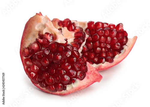 Pieces of ripe pomegranate on white background