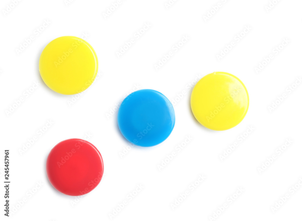 Bright magnets on white background, top view