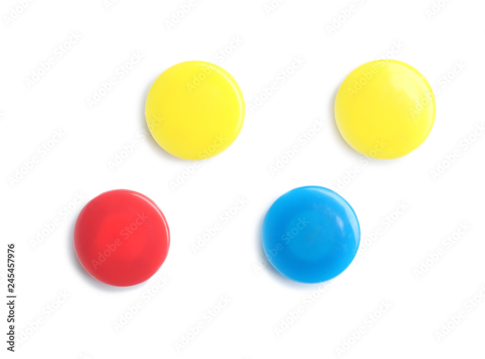 Bright magnets on white background, top view