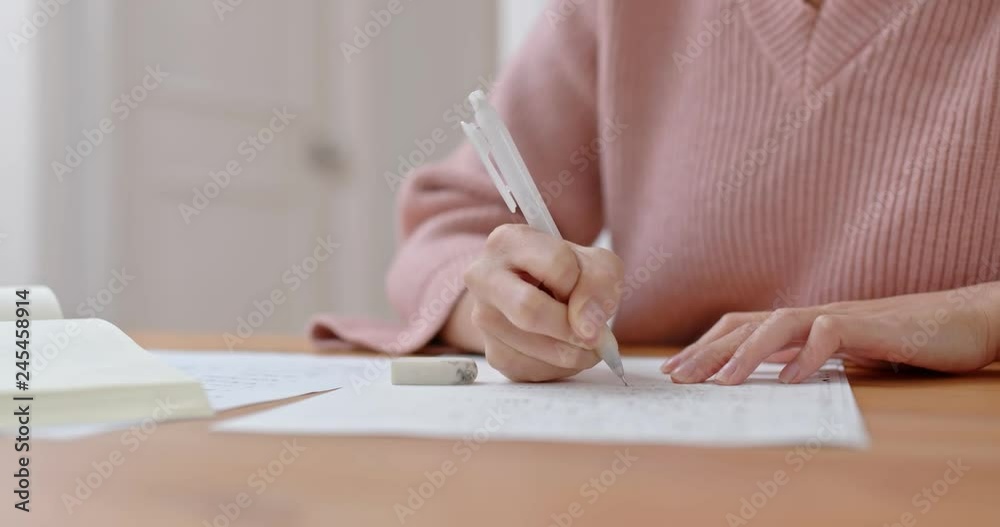 Woman write on the book at home