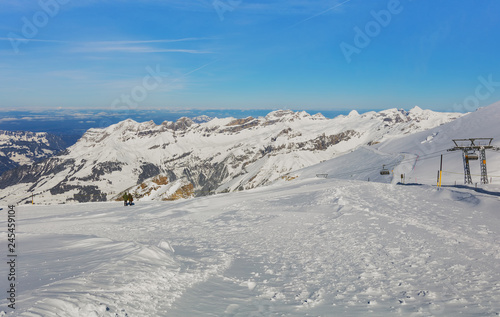View from Mt. Titlis in Switzerland in winter. The Titlis is a mountain, located on the border between the Swiss cantons of Obwalden and Bern, it is usually accessed from the town of Engelberg. © photogearch