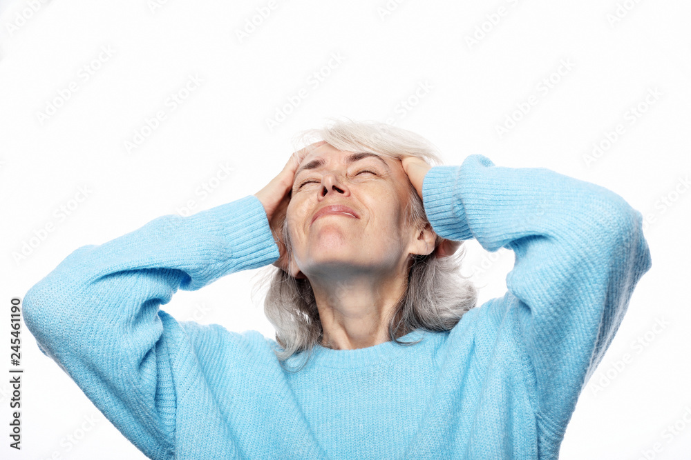 Lifestyle, health and people concept: senior lady having headache over white background Lifestyle, health and people concept: senior lady having headache over white background