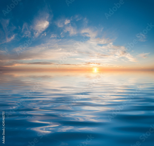 Sunset or sunrise over calm water