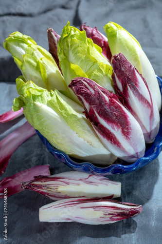 Group of fresh green Belgian endive or chicory and red Radicchio vegetables, also known as witlof salade photo