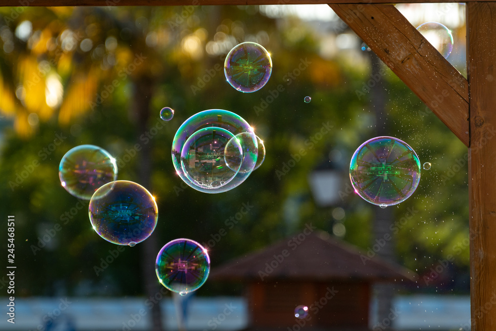 Many soap bubbles in air on city street, outdoor fun for everybody Many soap bubbles in air on city street, outdoor fun for everybody