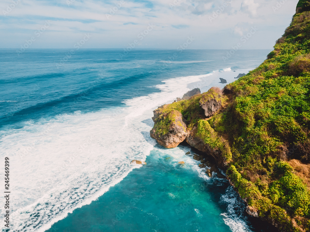 Aerial view of rocky coast and ocean in Bali, Indonesia.
