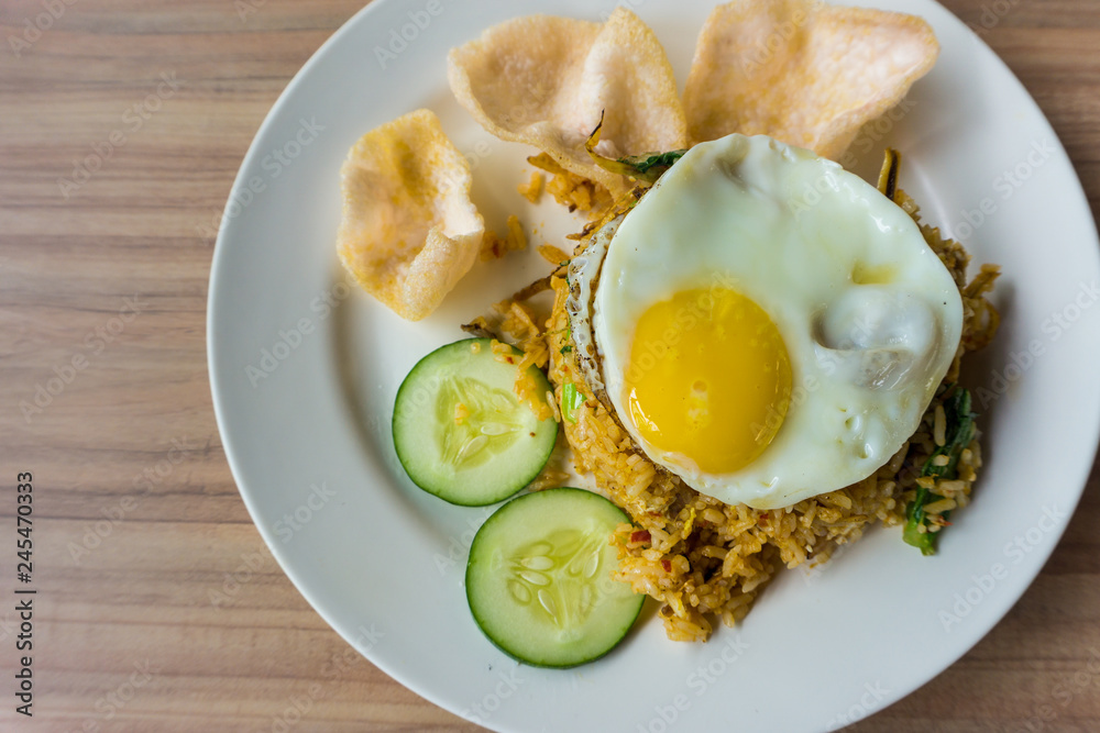 delicious fried rice and fried egg on the top serve on plate
