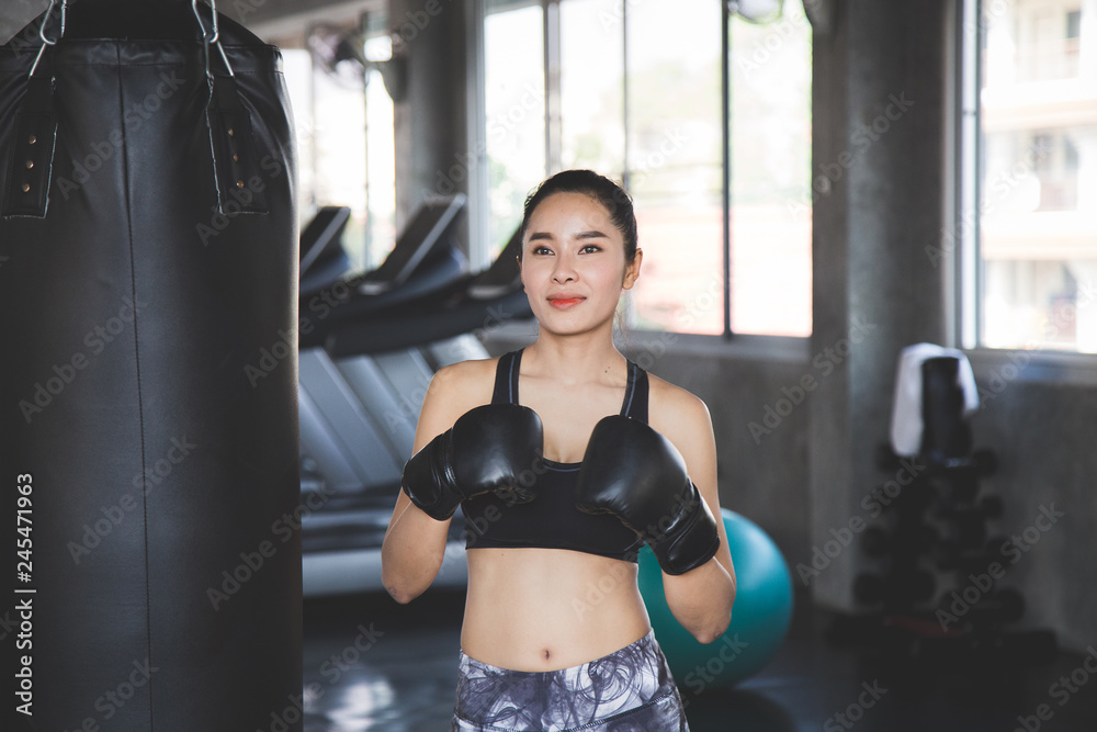 Beauty asian woman with boxing gloves at gym.