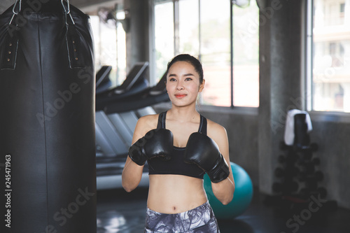Beauty asian woman with boxing gloves at gym. © Uraiwon