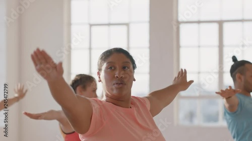 yoga class young overweight woman exercising healthy lifestyle practicing warrior pose enjoying weight loss fitness workout in studio at sunrise