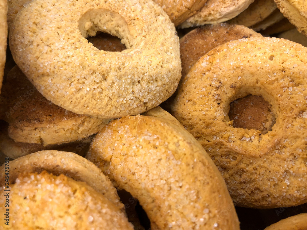 A bunch of crispy round bagel cookies. Cropped shot, background, horizontal, top view, nobody. The concept of healthy and harmful food.