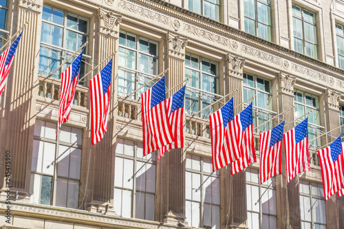 Many flags on the facade of The Saks Fifth Avenue department store in Midtown Manhattan in New York,USA