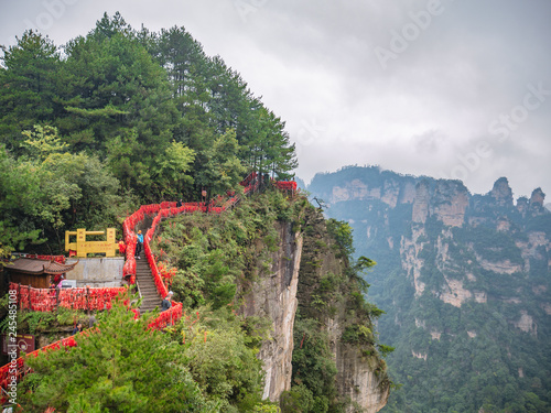 zhangjiajie/China - 14 October 2018: Unacquainted Tourists on Tianxiadiyiqiao  tianzi mountain in Zhangjiajie National Forest Park in Wulingyuan District Zhangjiajie City China in the Foggy day. photo