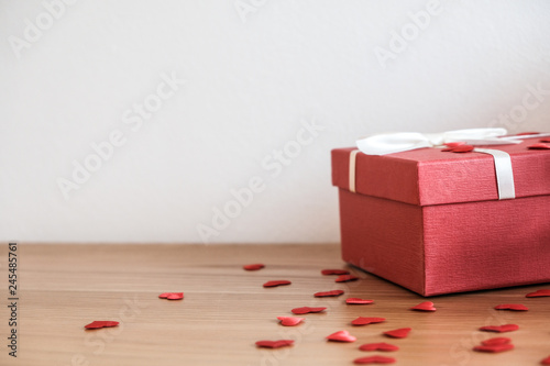 Valentine present. Gift box and red ribbon for romantic couple.