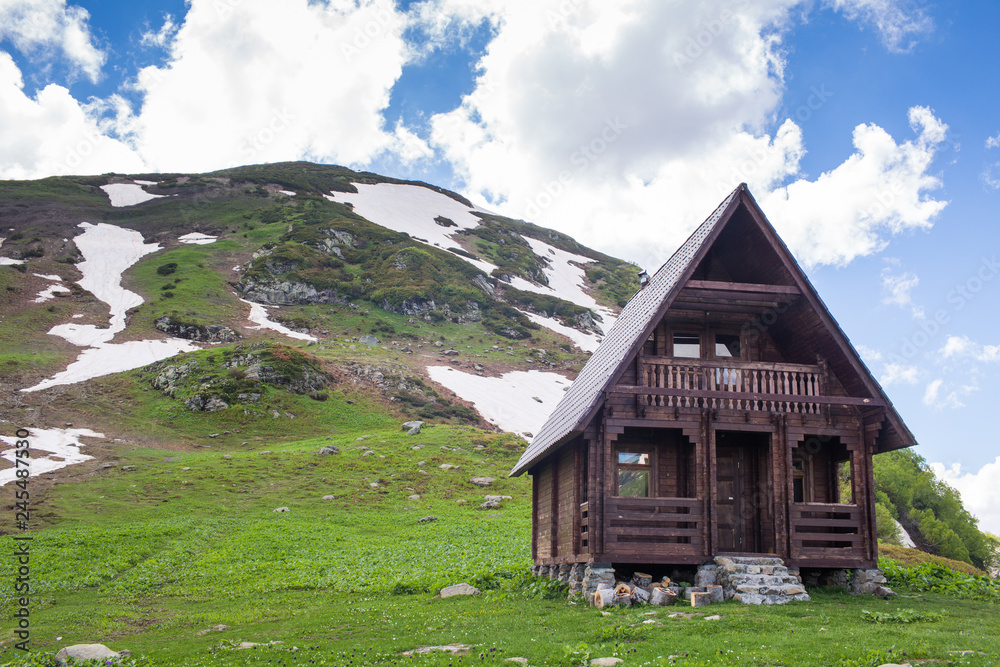 wooden two-storey house in the mountains