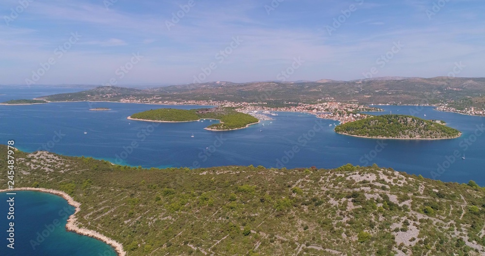 Mediterranean village, C4k aerial, drone shot, towards the Rogoznica town, the blue, adriatic sea, on the croatian coast, on a sunny, summer day, in Croatia