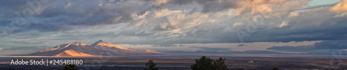 Antelope Island view from Magna, sweeping cloudscape at sunrise with the Great Salt Lake State Park in winter. USA, Utah. photo
