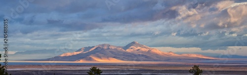 Antelope Island view from Magna, sweeping cloudscape at sunrise with the Great Salt Lake State Park in winter. USA, Utah. photo