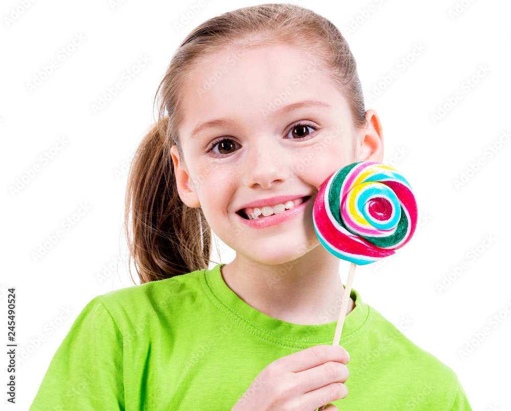 Smiling girl in green t-shirt with colored candy.