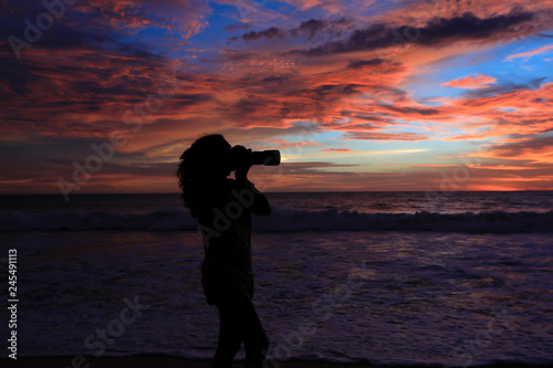 Girl Photographer Taking Pictures With Dslr Camera At Sunset On The Beach