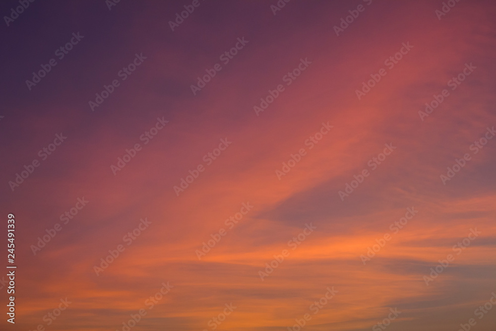 bright pink and yellow clouds in a dark blue purple sunset sky