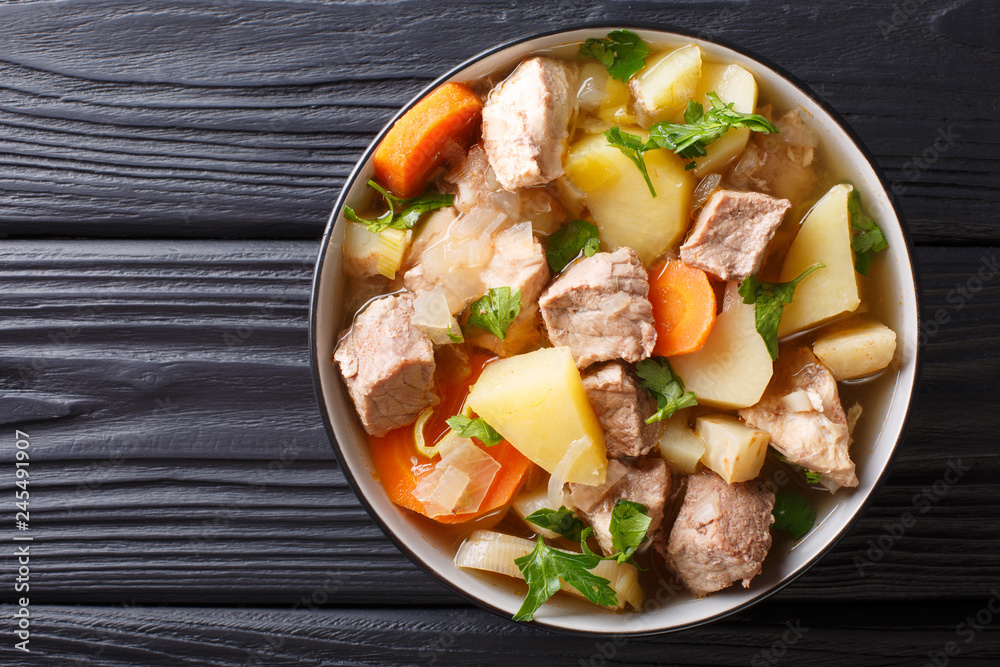 German stew Pihelsteiner with vegetables and three kinds of meat close-up in a bowl. horizontal top view