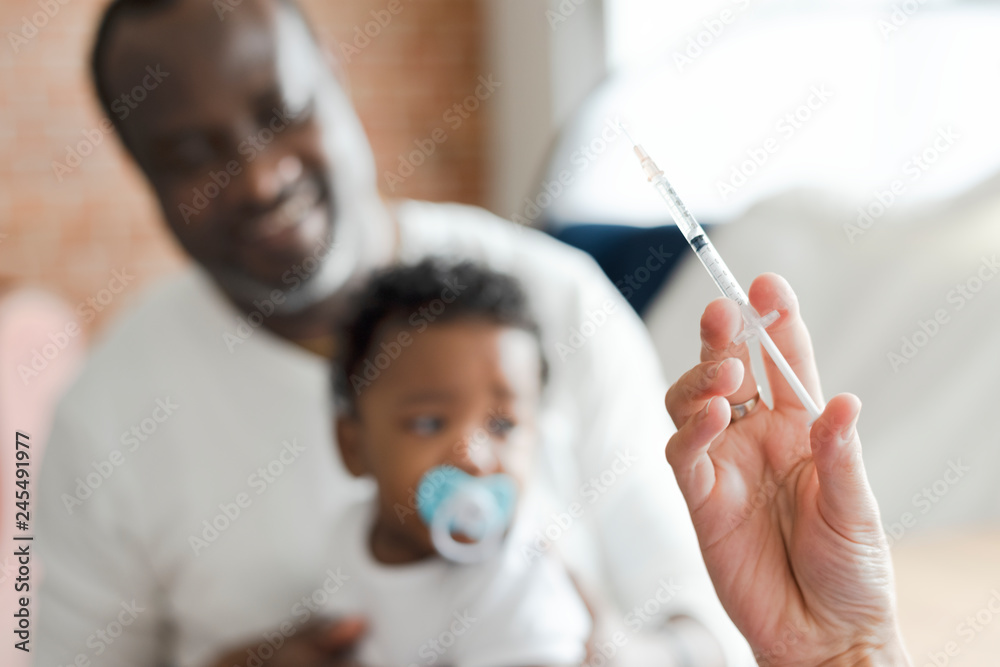 Naklejka premium Baby getting a first injection