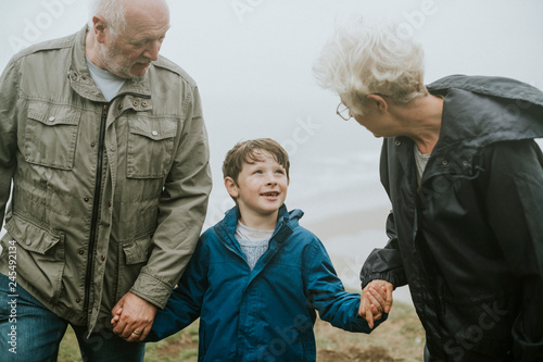 Happy boy enjoying with his grandparents photo