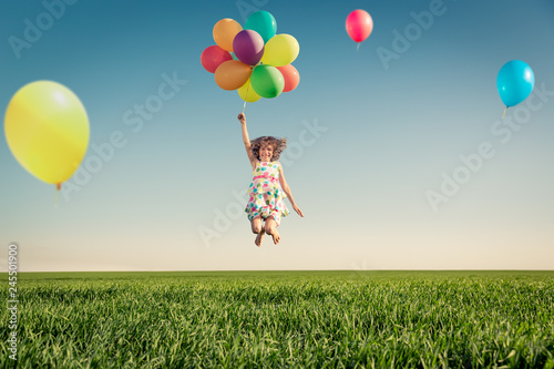 Happy child playing outdoors in spring field