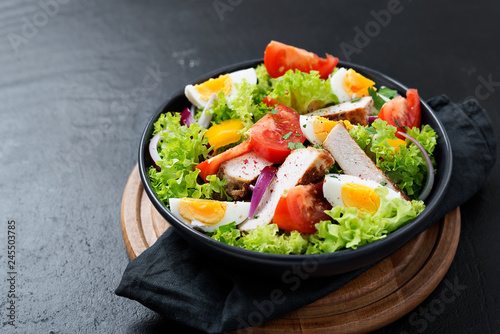 Fresh vegetable salad with chicken breast and eggs.