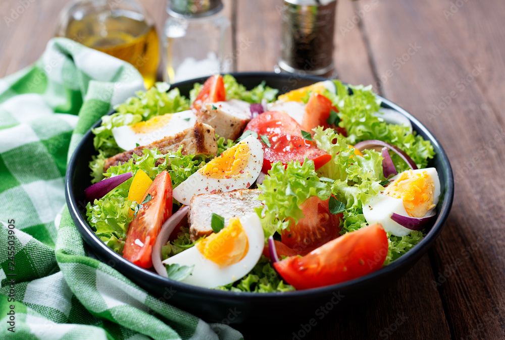 Fresh vegetable salad with chicken breast and eggs.